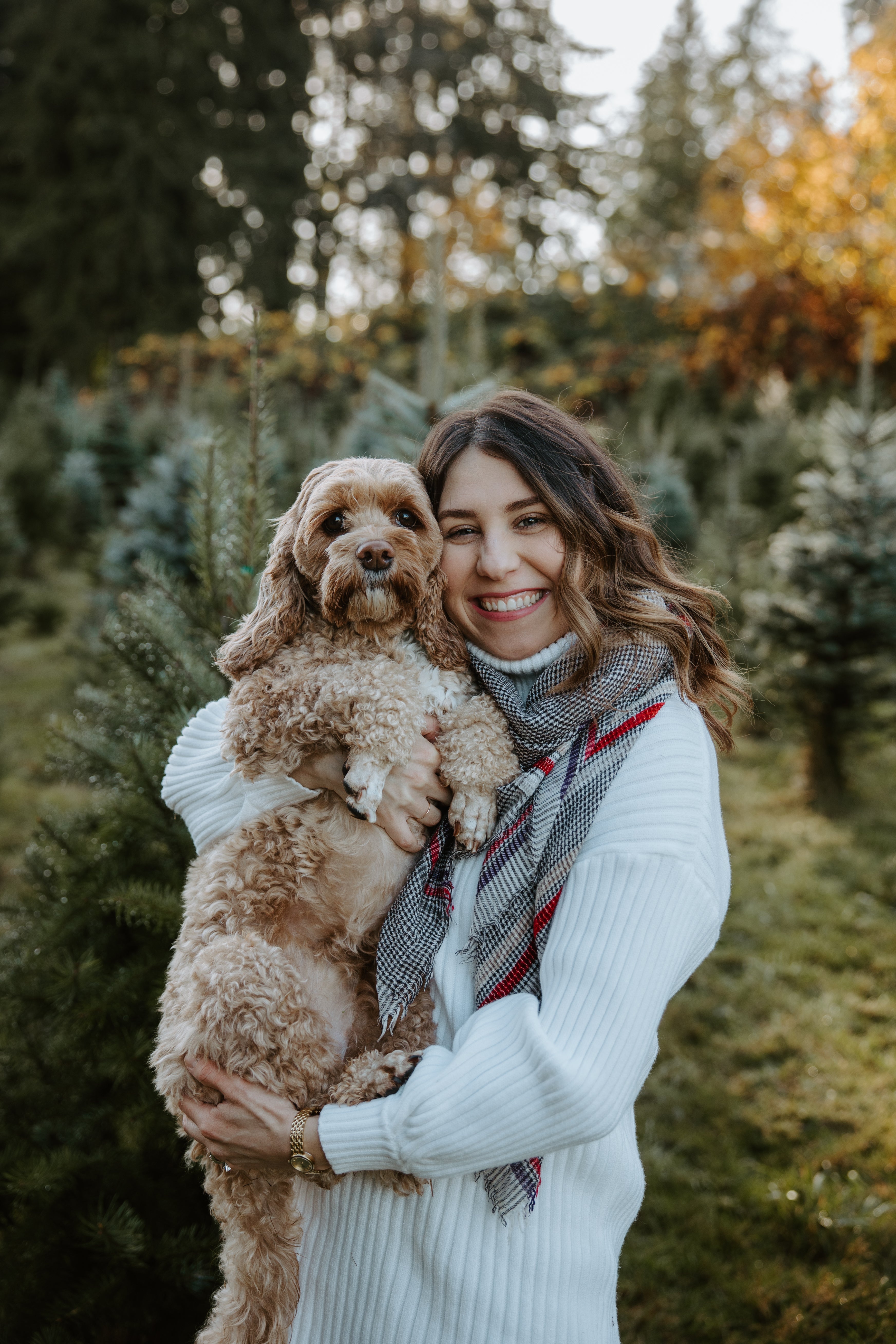 women holding a dog at a christmas tree farm